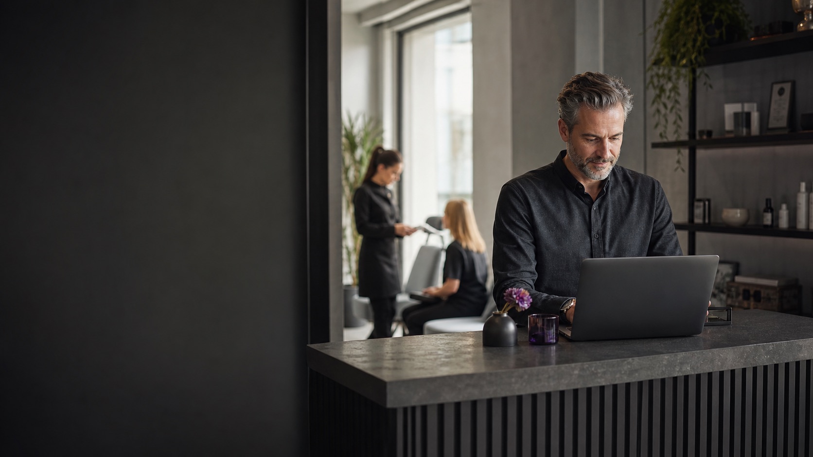 Service business owner managing daily bookings from a reception workspace